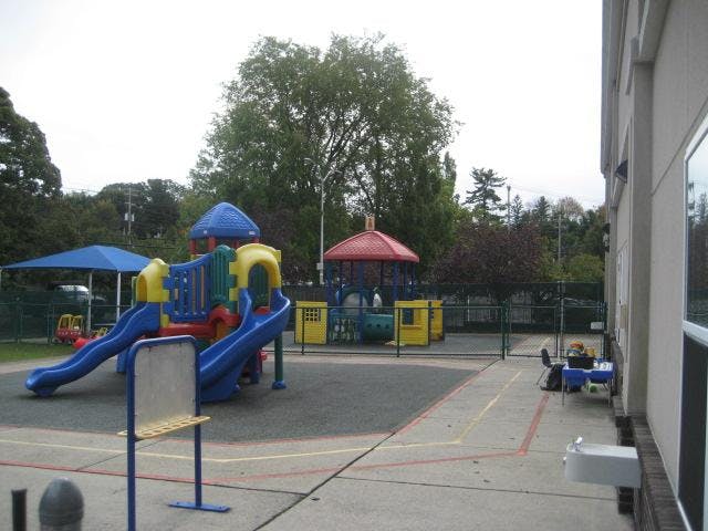 Colorful playground equipment with slides and a blue canopy