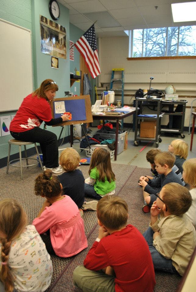 Person teaching children in a classroom