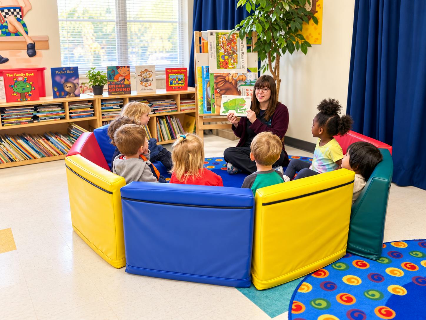 Adult reading a book to a group of children sitting in a circular play area