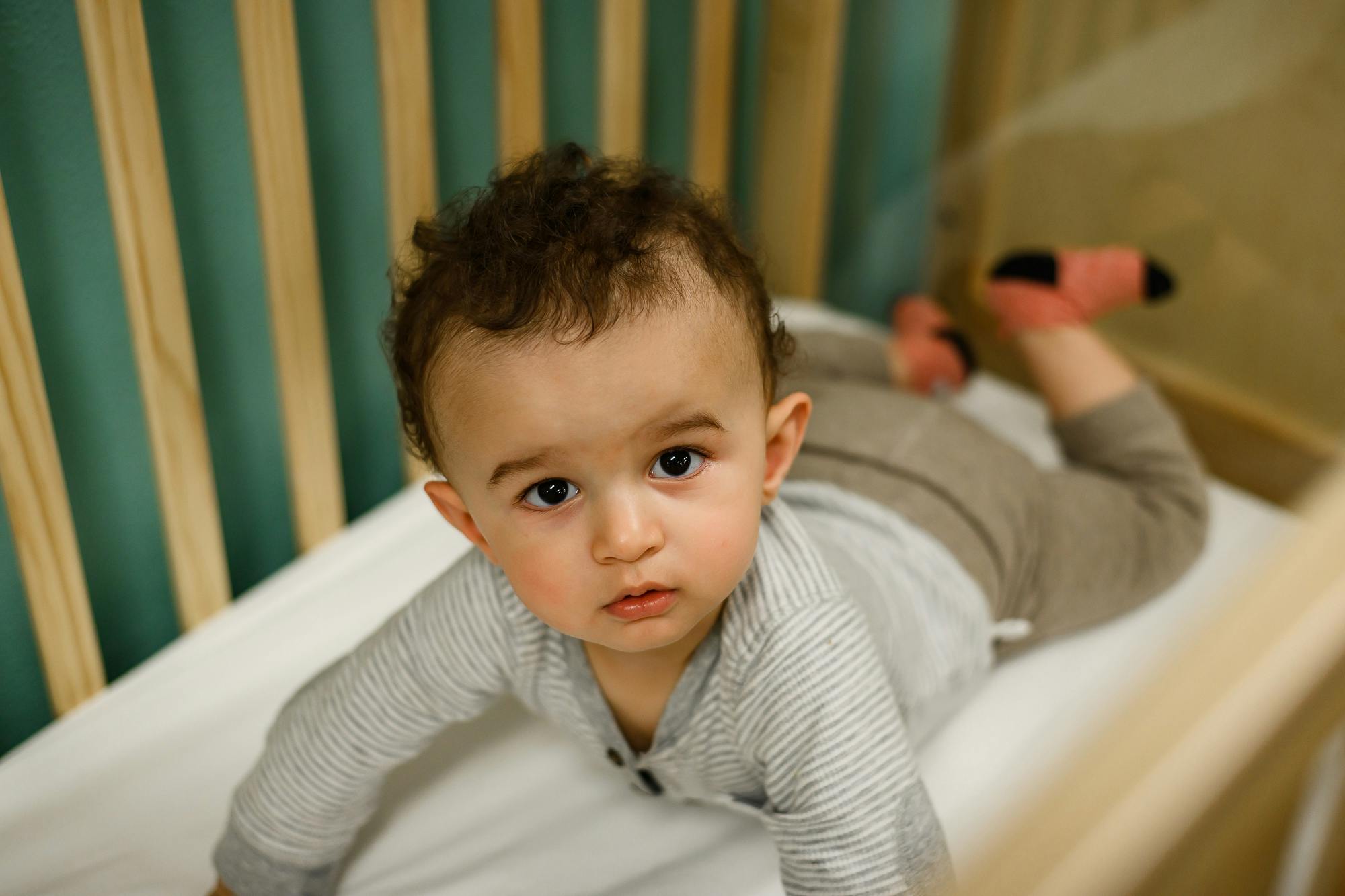 Child in a crib looking forward