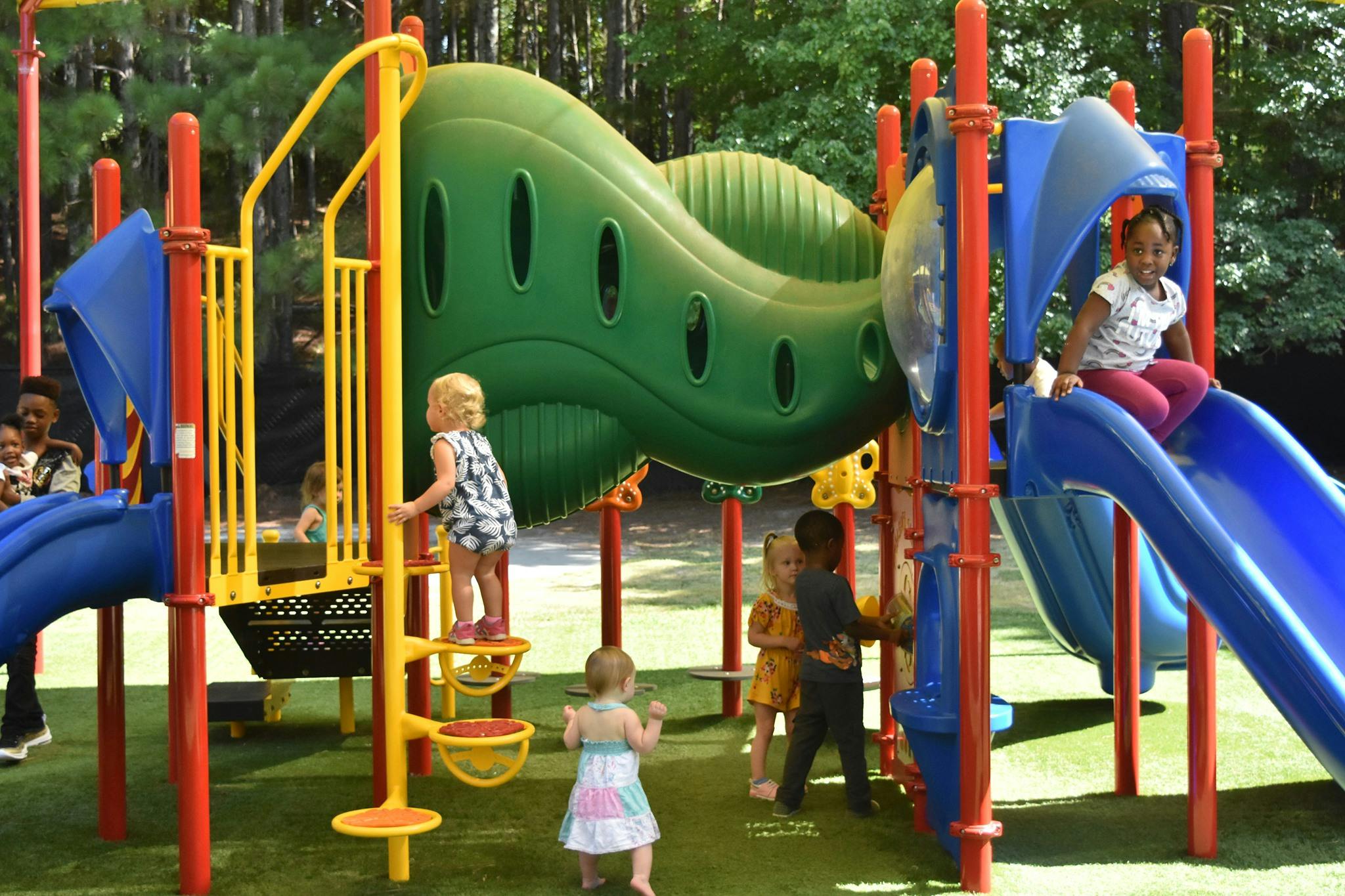 Children playing on a colorful playground structure