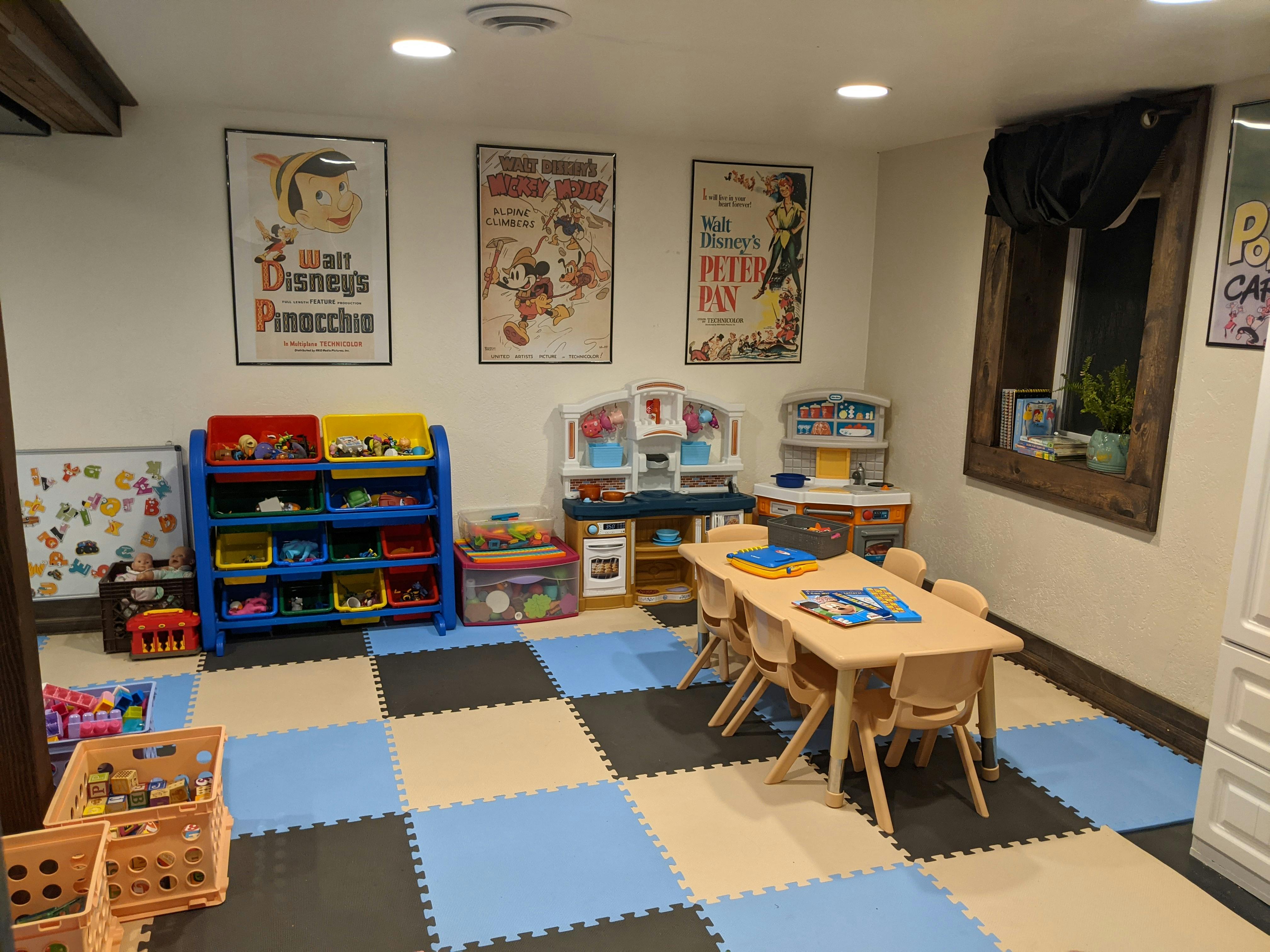Playroom with toy storage, play kitchen, and small table with chairs