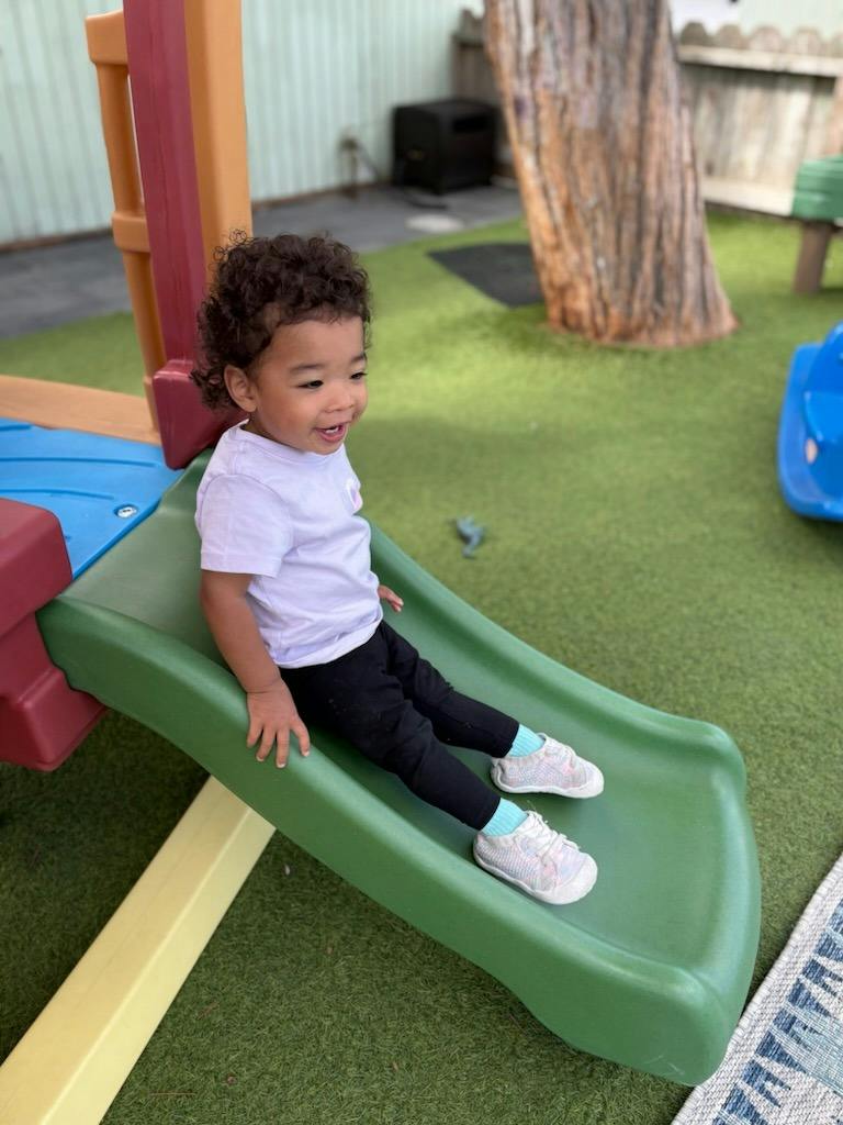 Child sitting on a playground slide