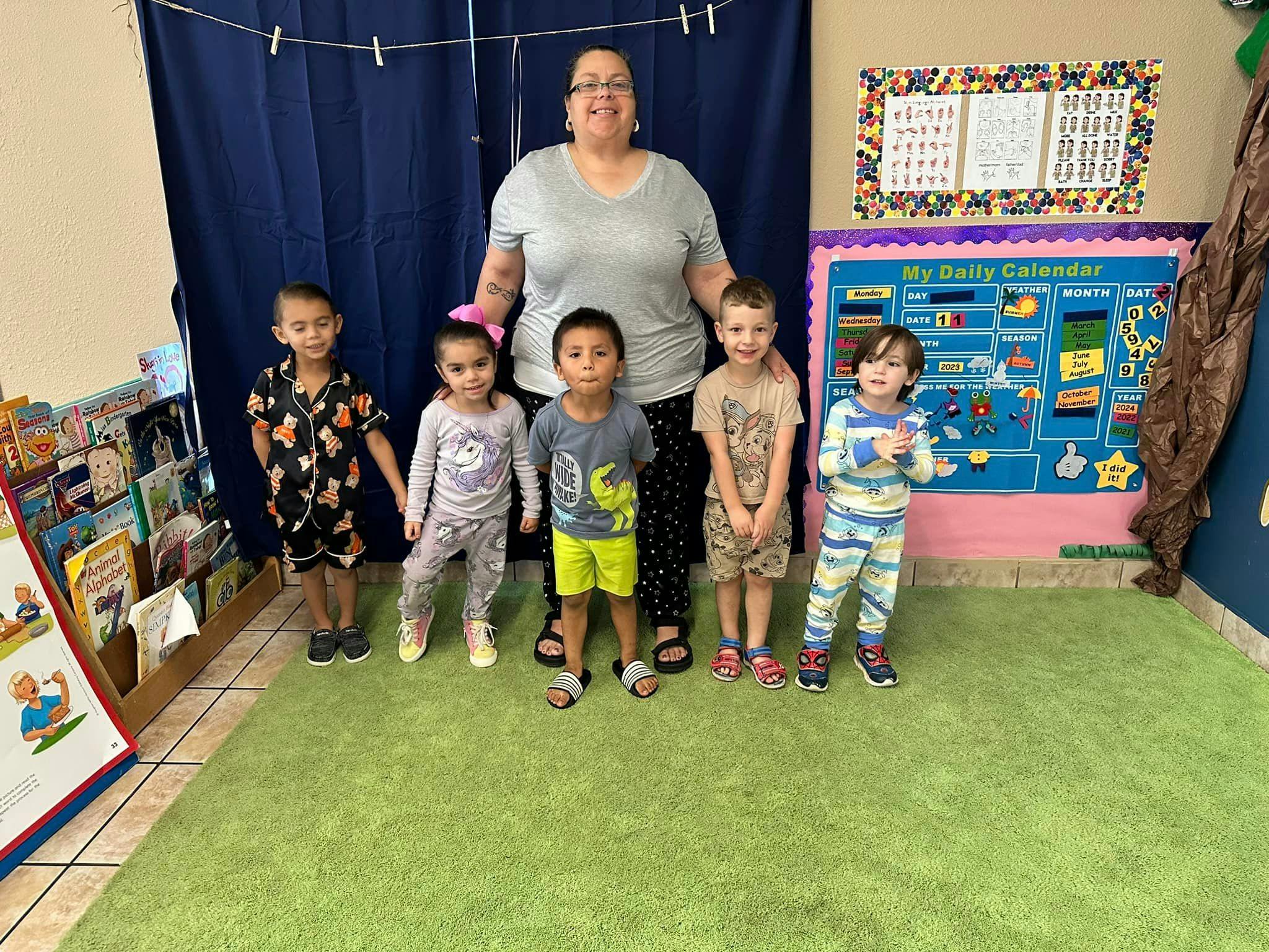 Adult and five children standing in a room