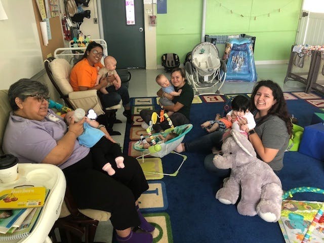 People with babies in a room