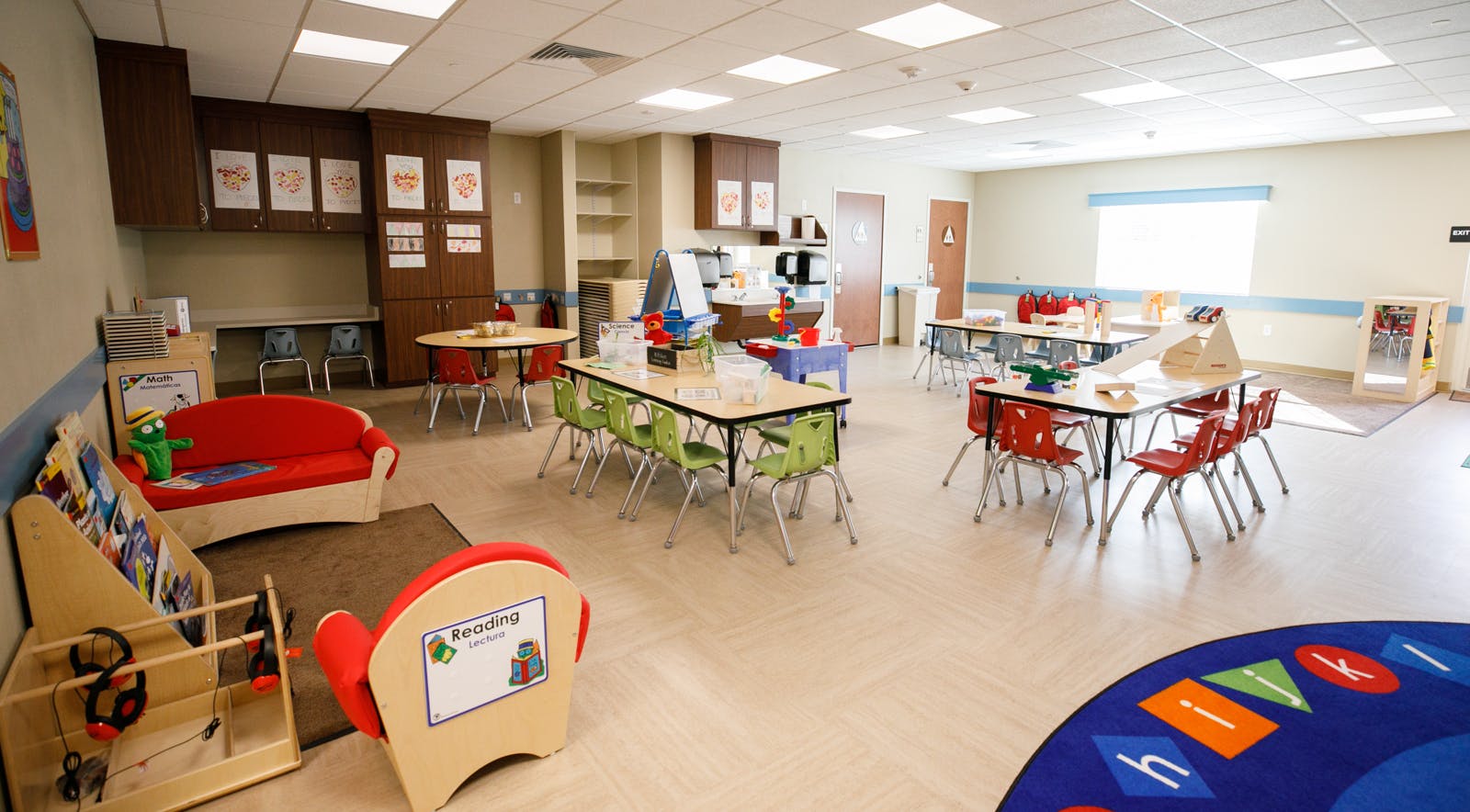 Empty classroom with small tables and chairs