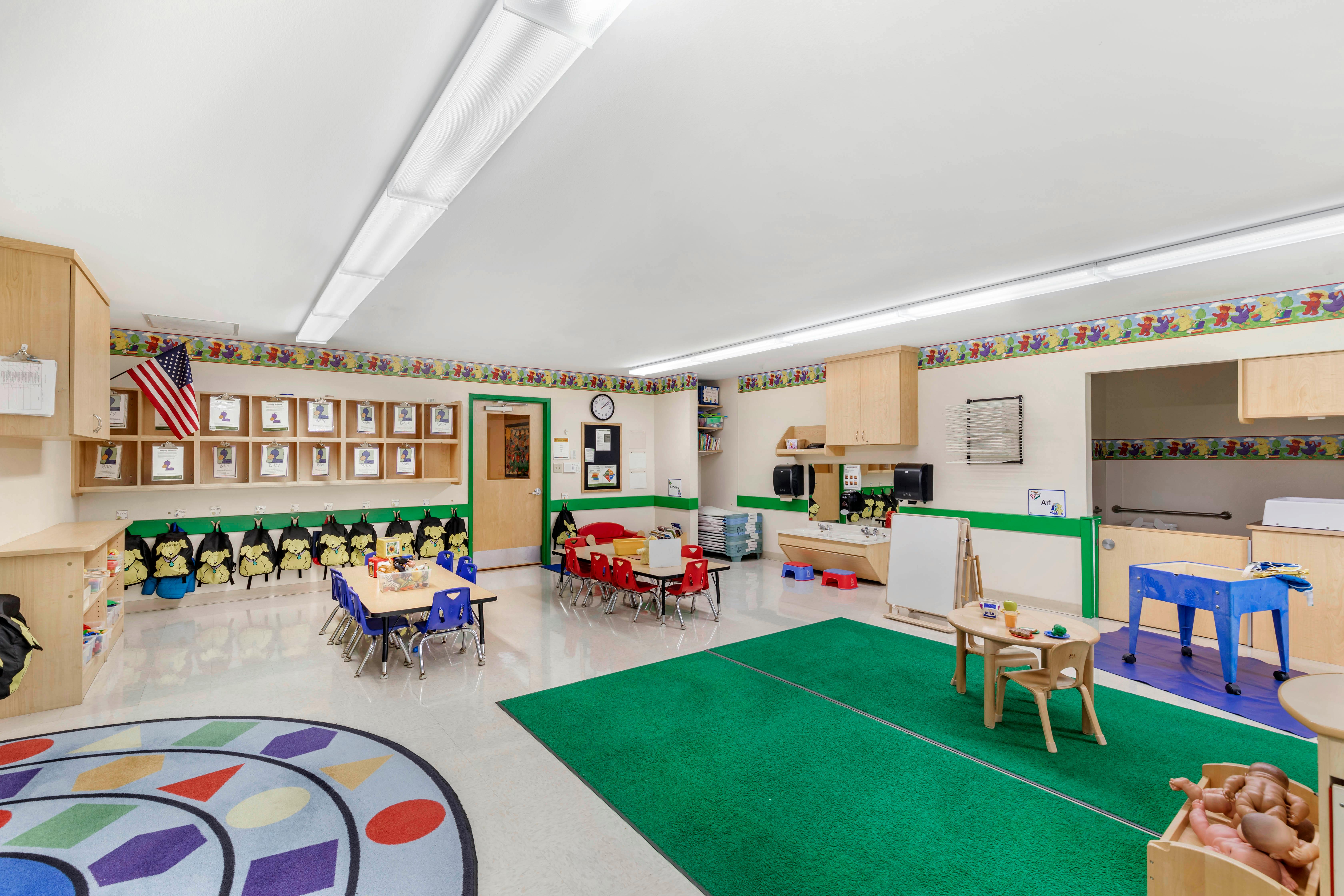 A colorful daycare or preschool classroom with small tables and chairs
