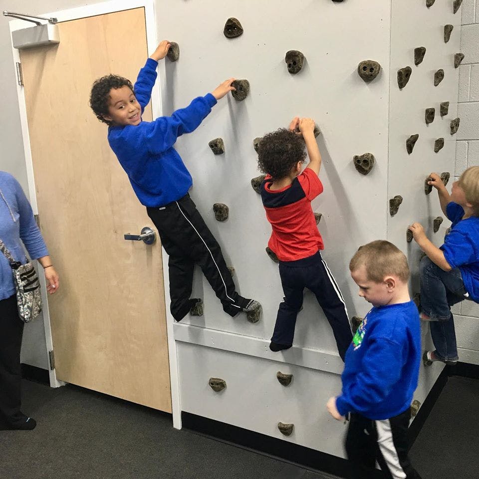 Children climbing on an indoor rock wall
