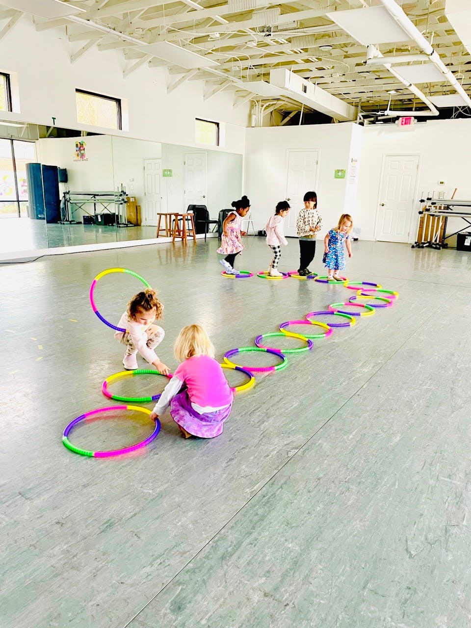 Children playing with colorful hoops on the floor