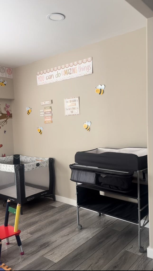 Nursery room with a crib, changing table, and wall decorations