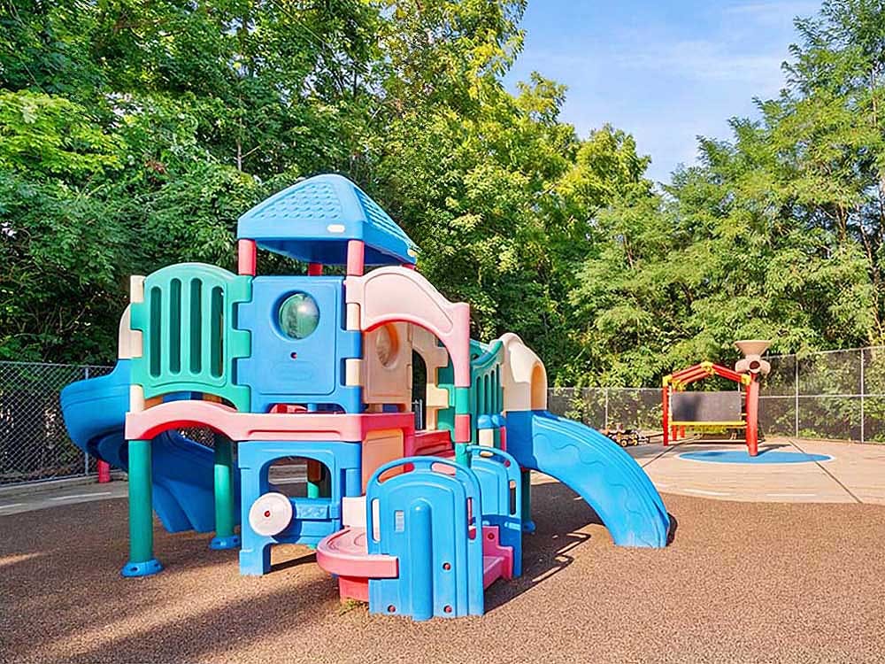 Colorful playground with slides and climbing areas on a rubberized surface