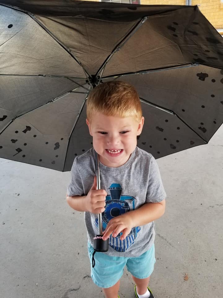 Child holding an open umbrella