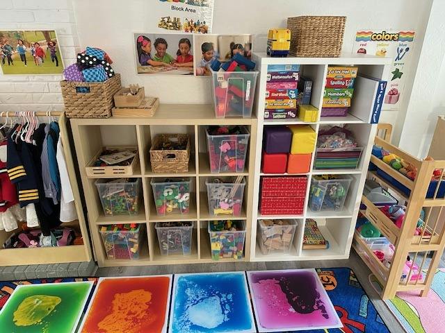 Classroom shelves filled with organized toys and play materials