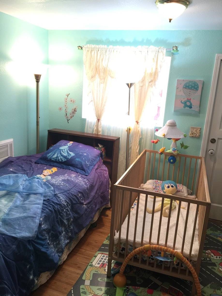 Bedroom with a bed and a crib