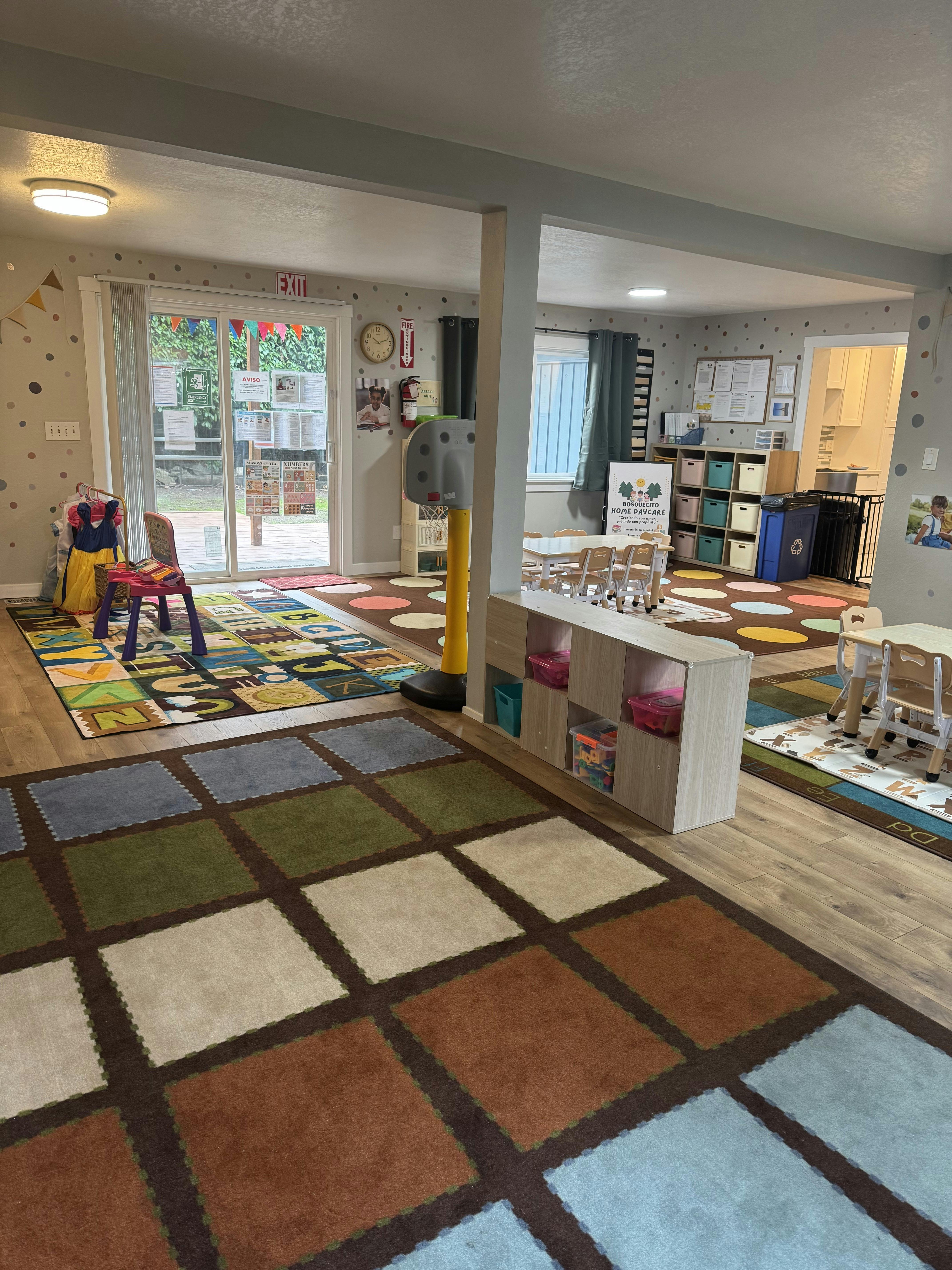 Colorful playroom with children's furniture, rugs, and decorations