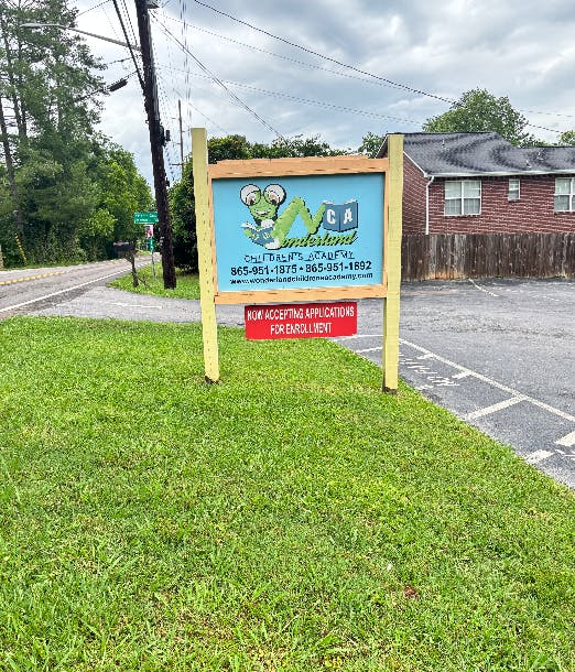 Wonderland Children Academy sign with enrollment information