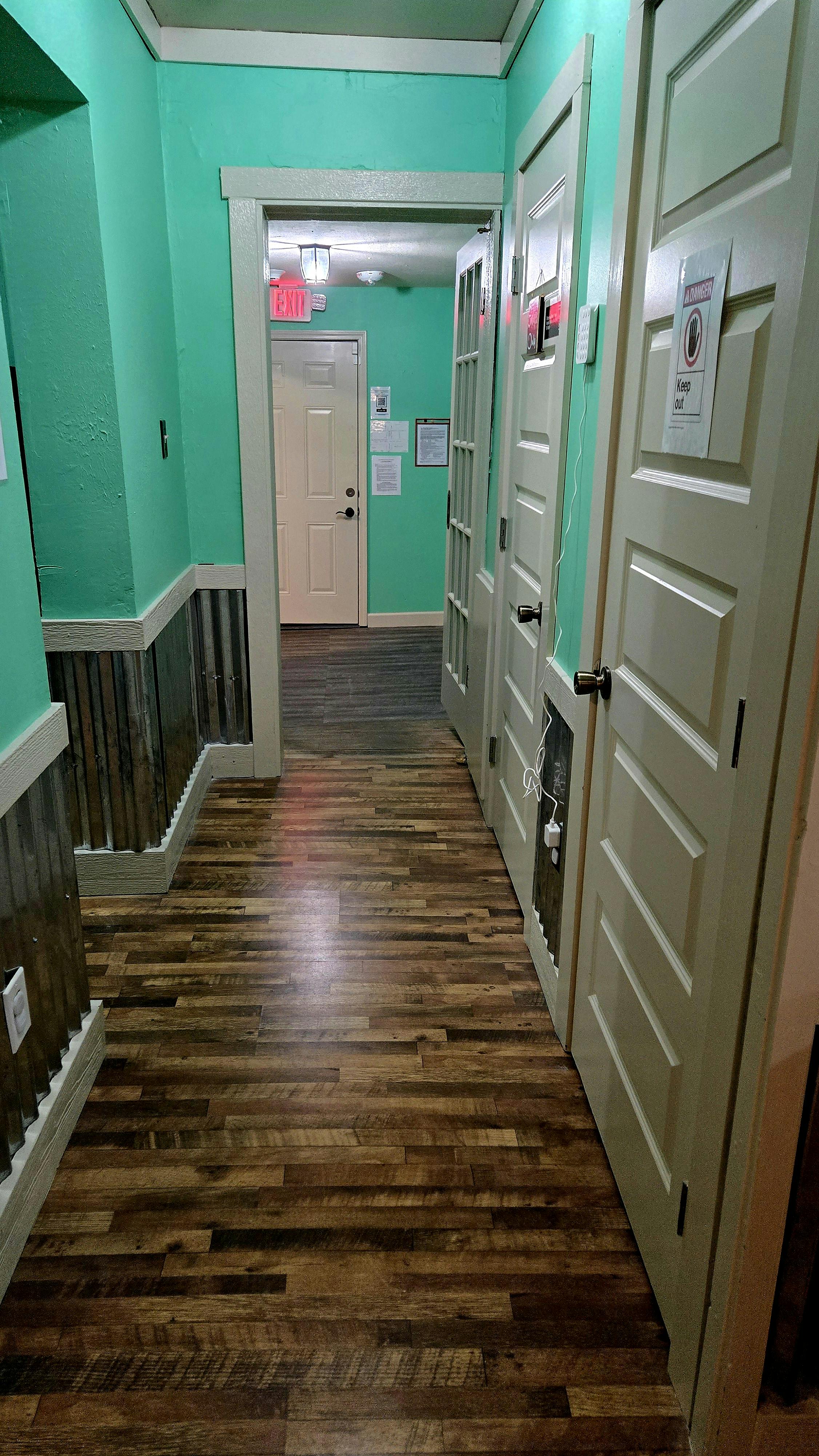 Hallway with wood floor and multiple doors