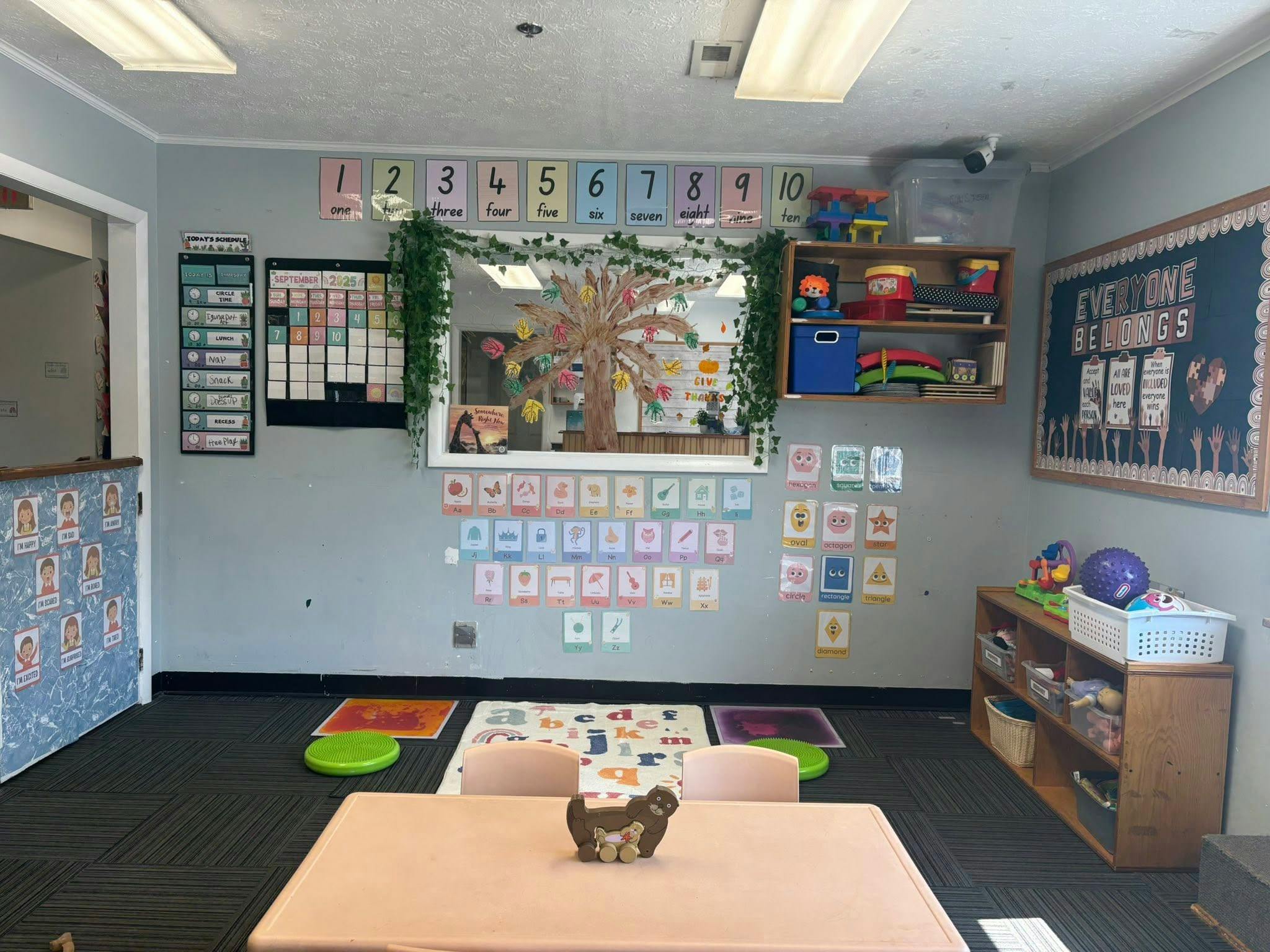 Classroom with numbers, letters, shapes, and schedules on the walls