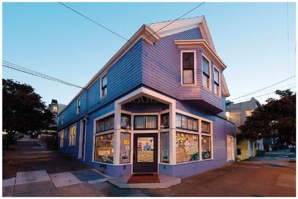 Corner building with blue and purple siding and large windows