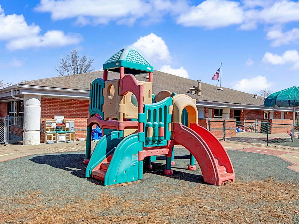 Colorful outdoor playground structure with slides and climbing areas