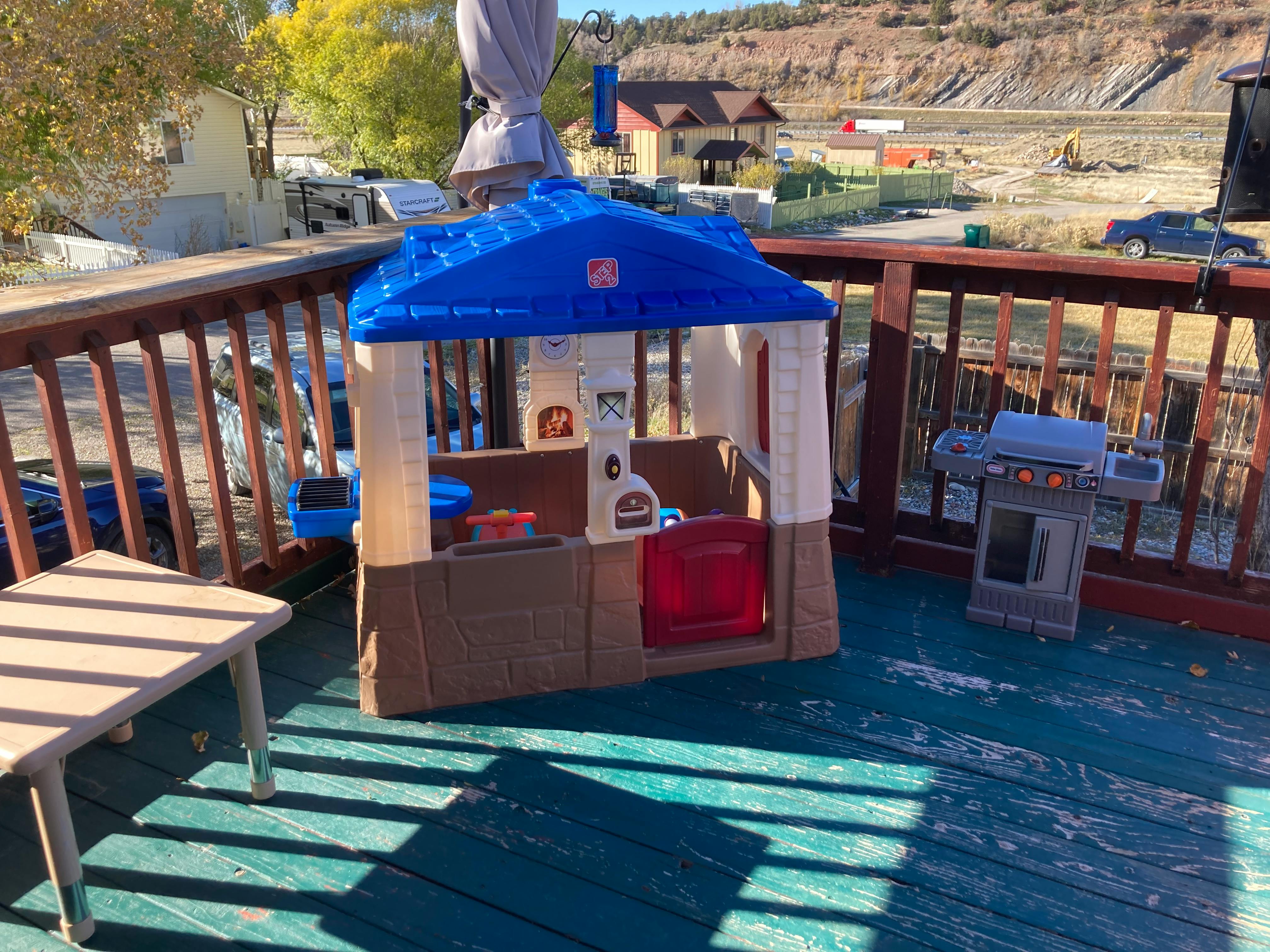 Playhouse and toy grill on a deck