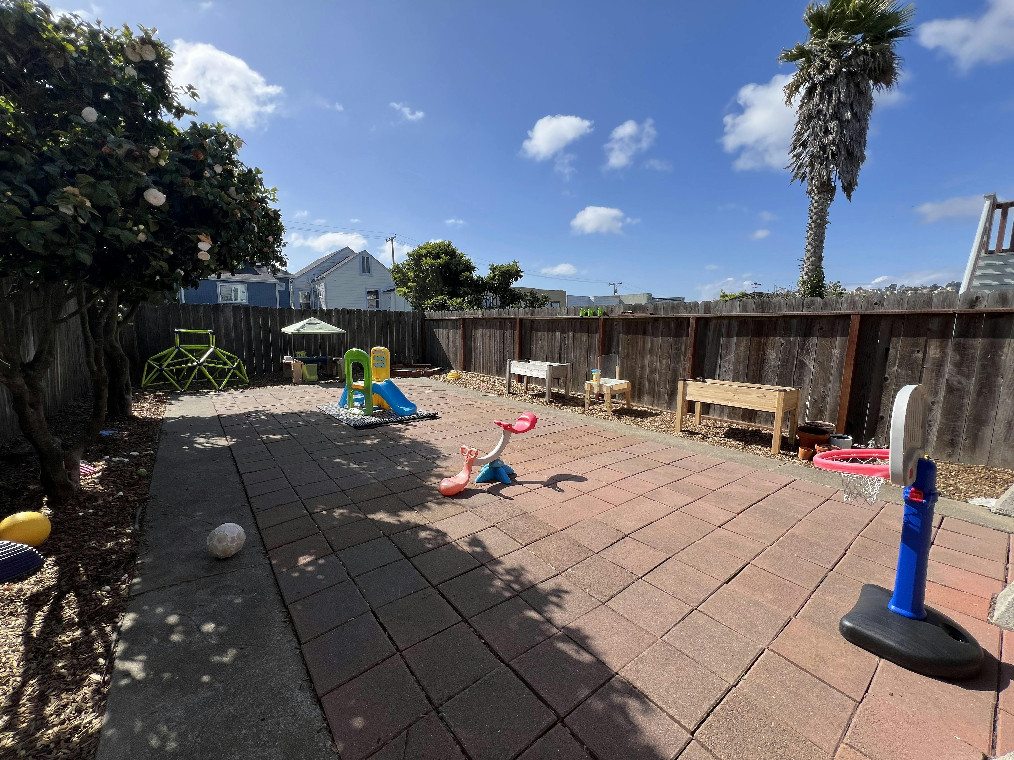backyard patio with various children's play equipment
