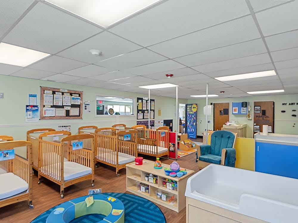 Cribs and childcare furniture in a bright room