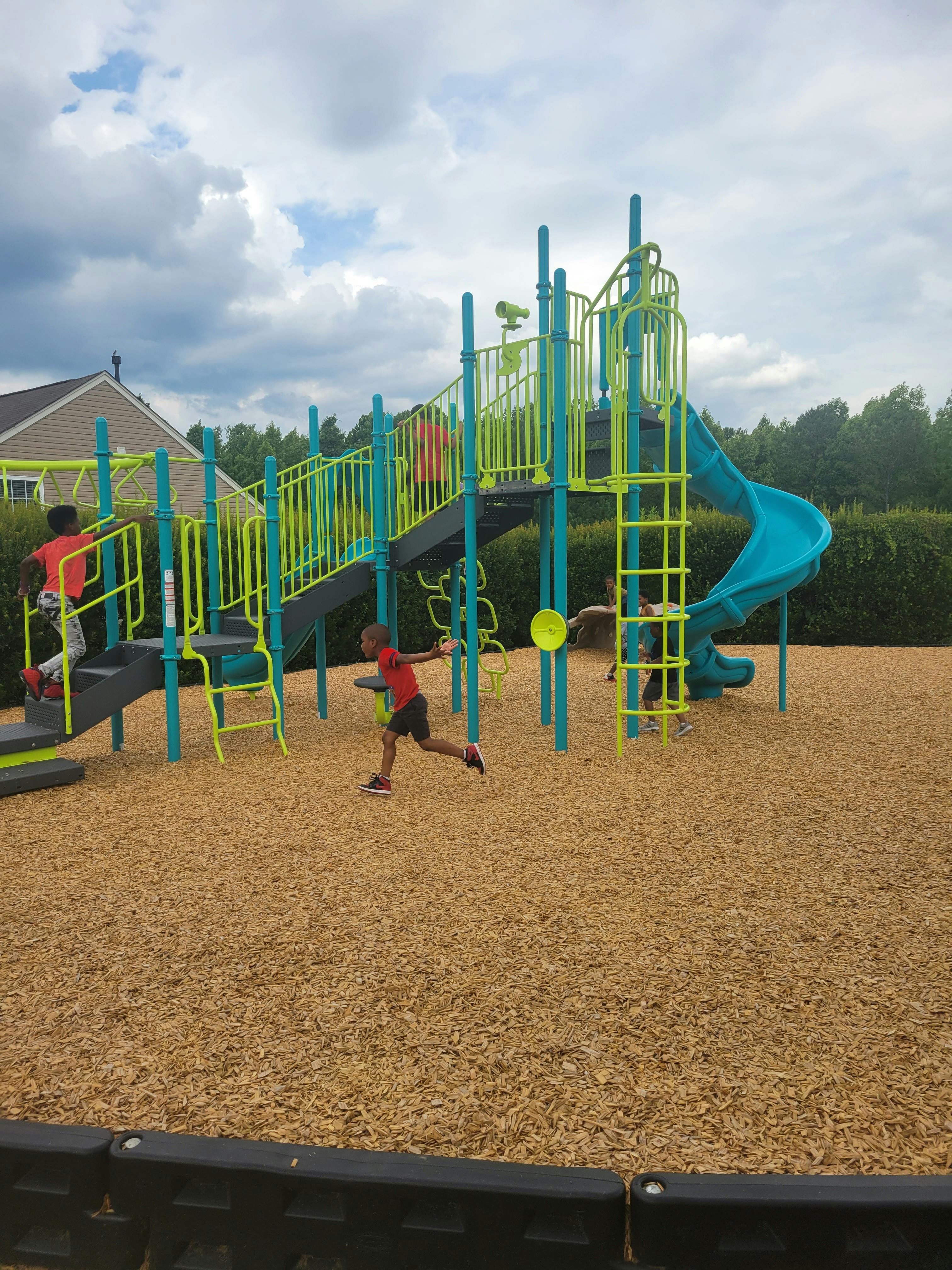 Two children playing on a playground structure