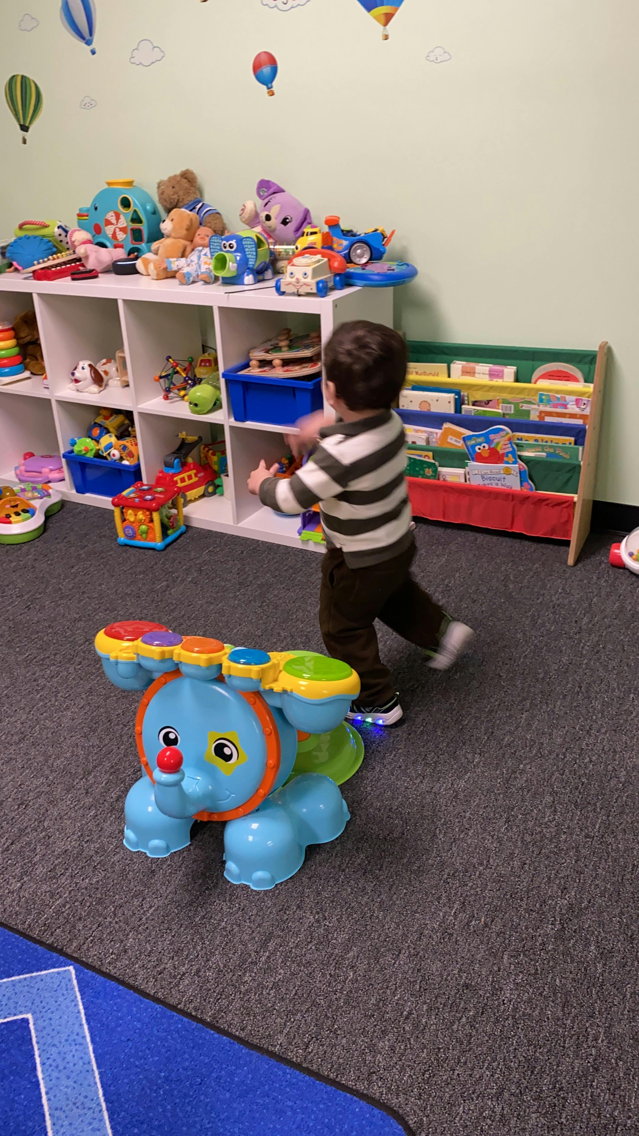Child playing with toys in a room