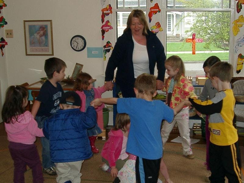 Adult and children holding hands in a circle