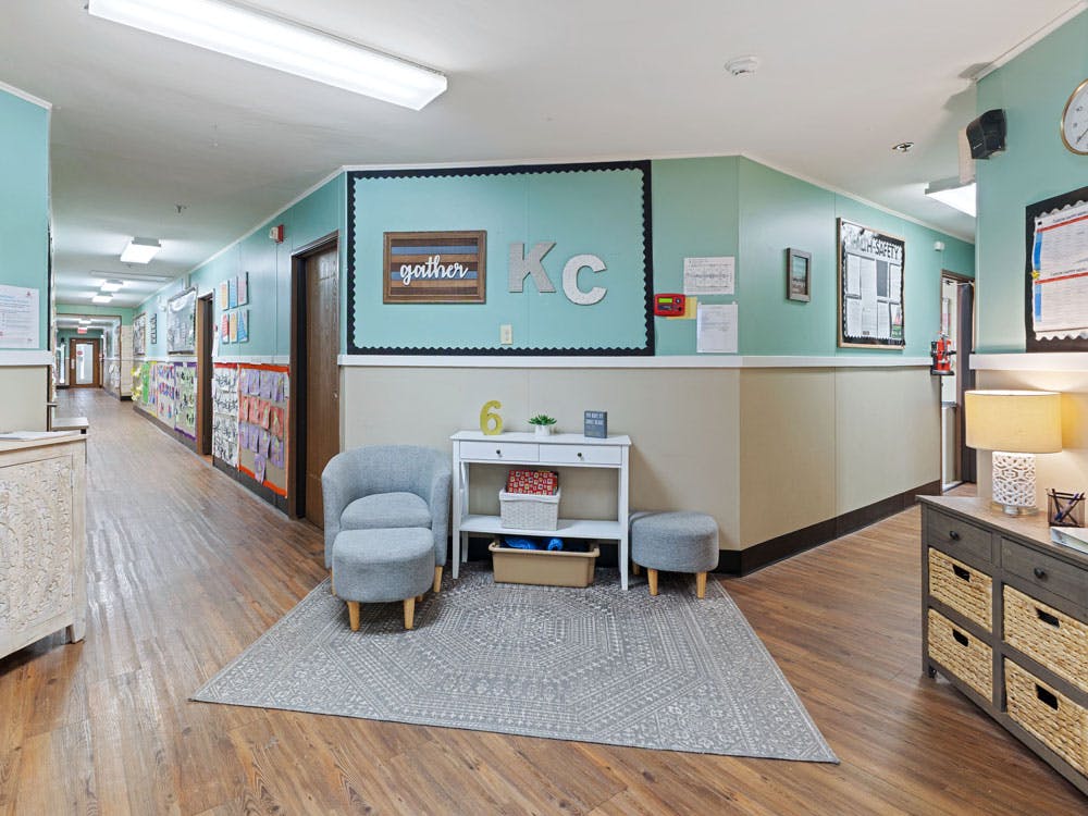 Hallway with a bulletin board displaying the word "gather"