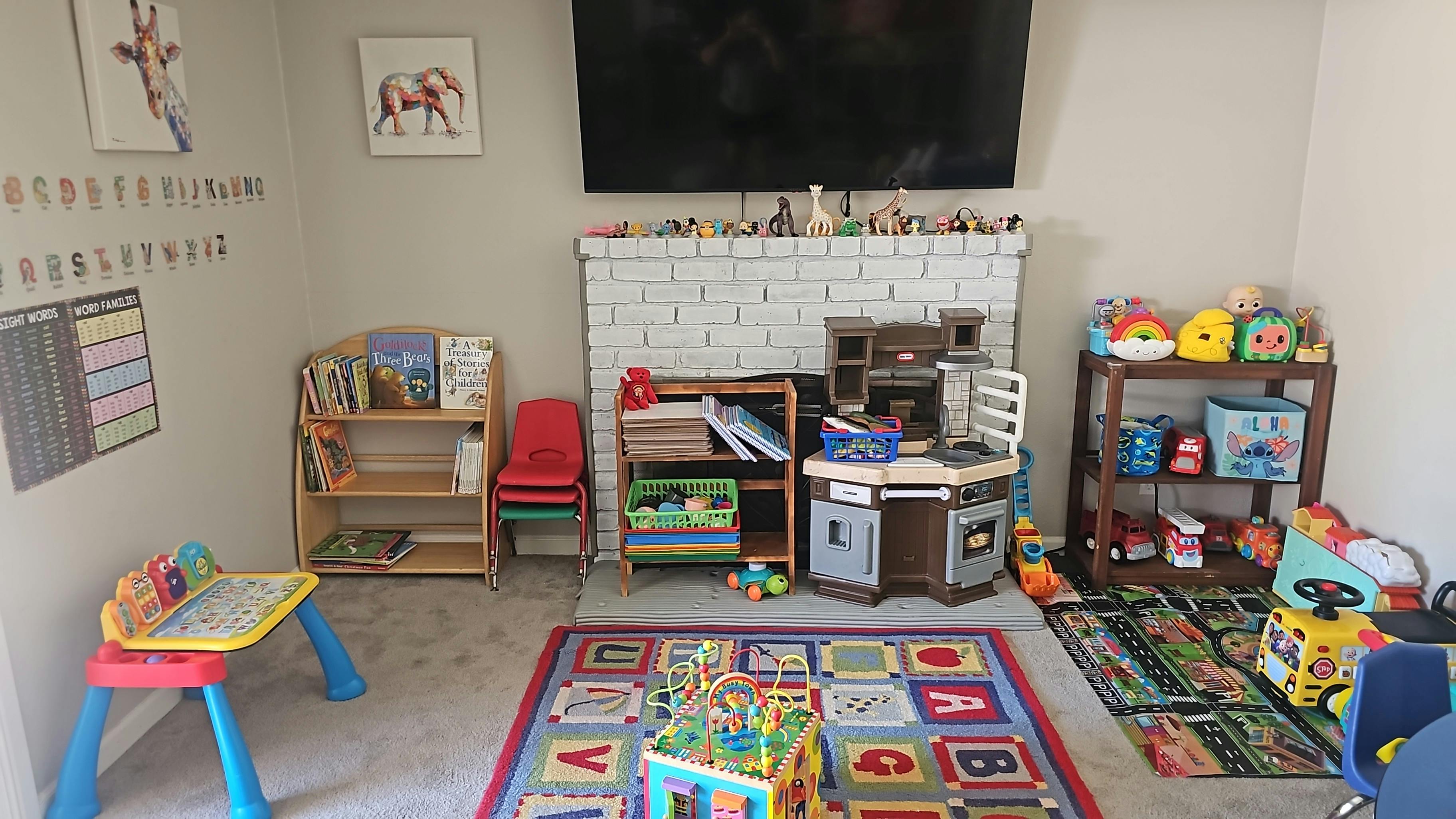 Playroom with toys, bookshelves, and a play kitchen
