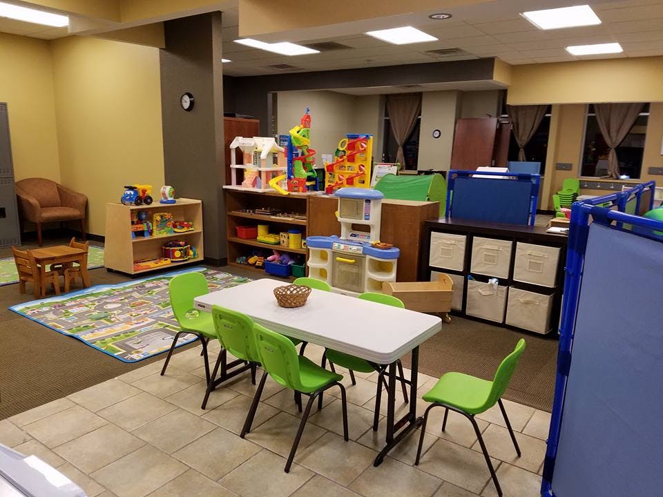 Children's play area with tables, chairs, and toys