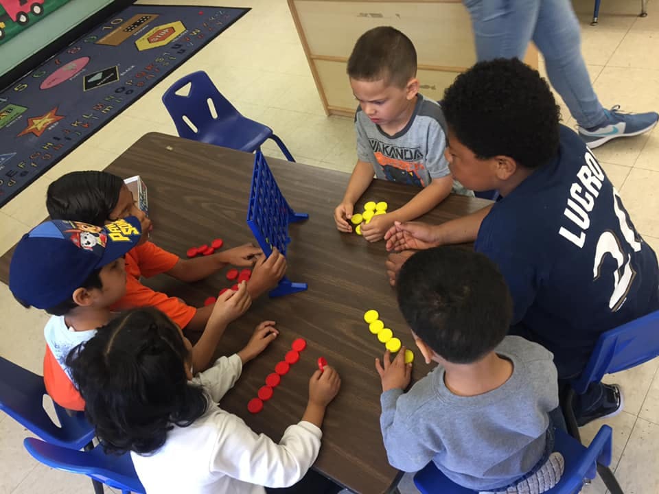 Children playing a board game at a table