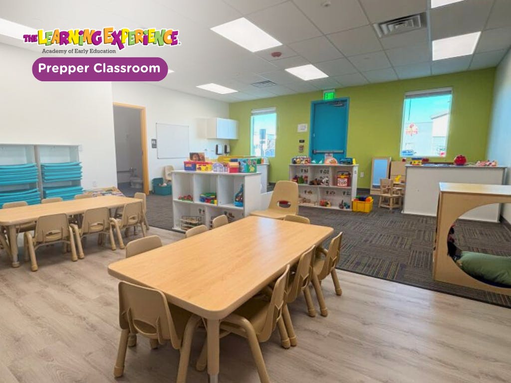 Classroom with child-sized tables and chairs and toys on shelves