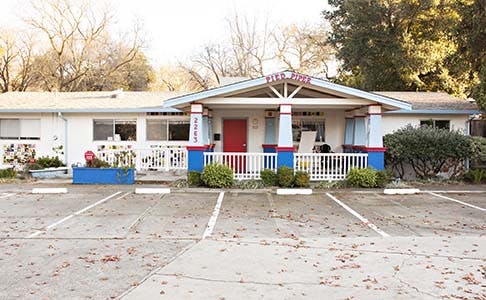 Building with a red door and blue and white columns
