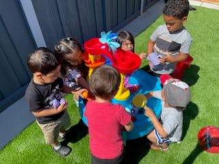 Children playing with a water table outdoors