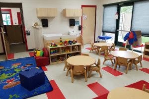 Empty classroom with small tables and chairs