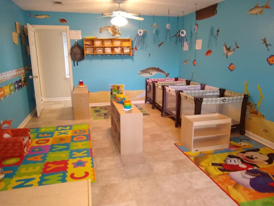 Nursery room with multiple cribs and play mats