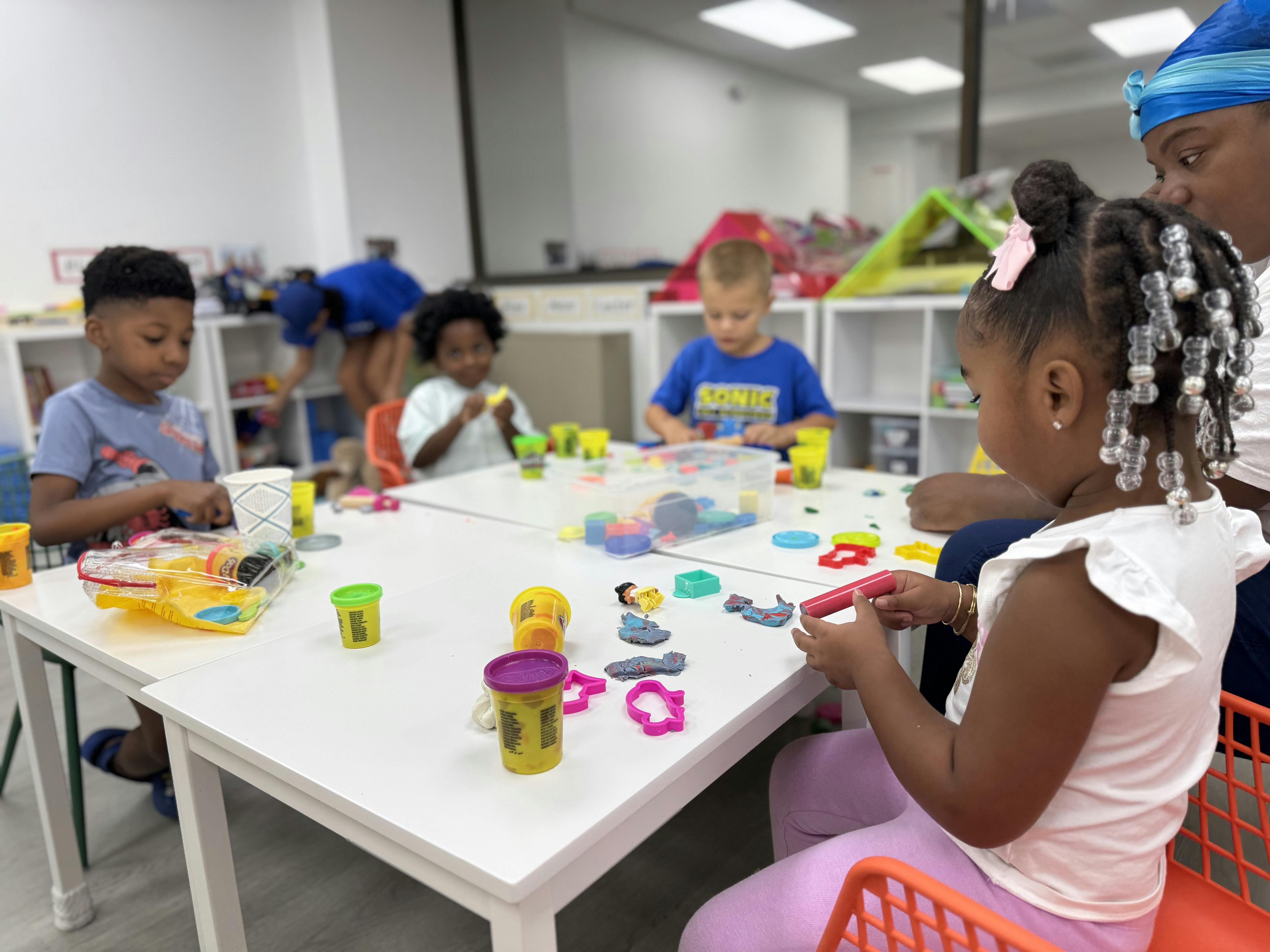 Children playing with modeling clay at a table