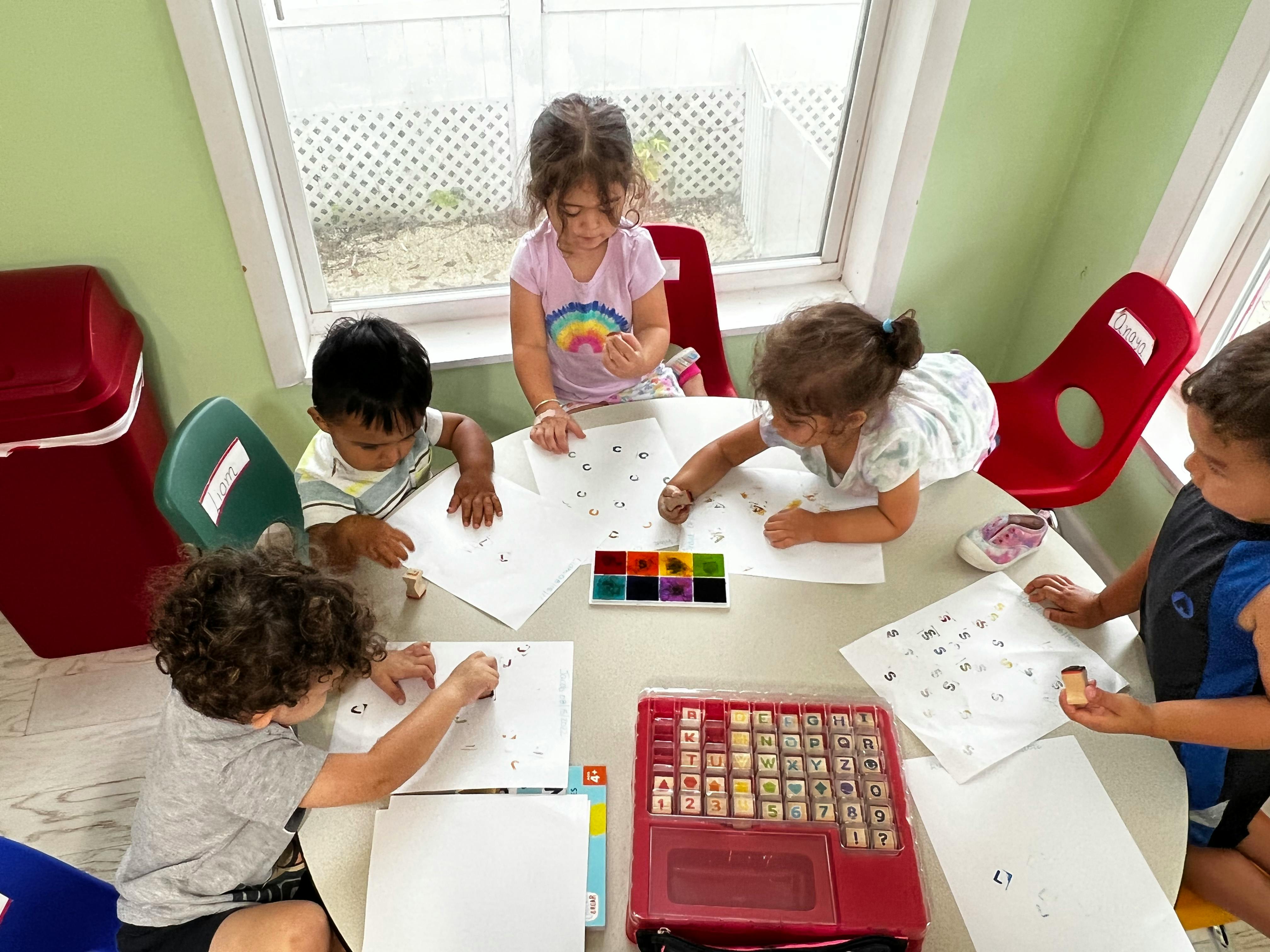 Children drawing and painting at a table
