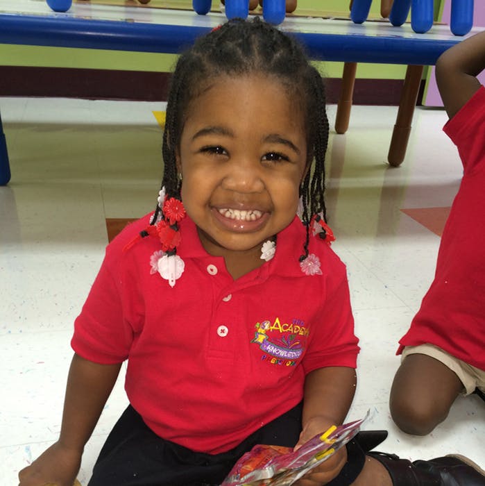 Child in a red shirt smiling