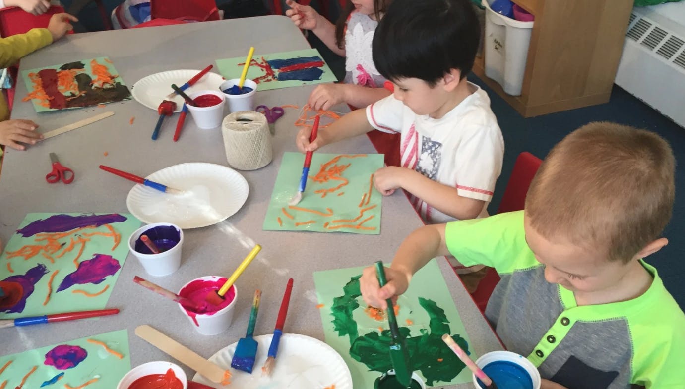 Children painting at a table