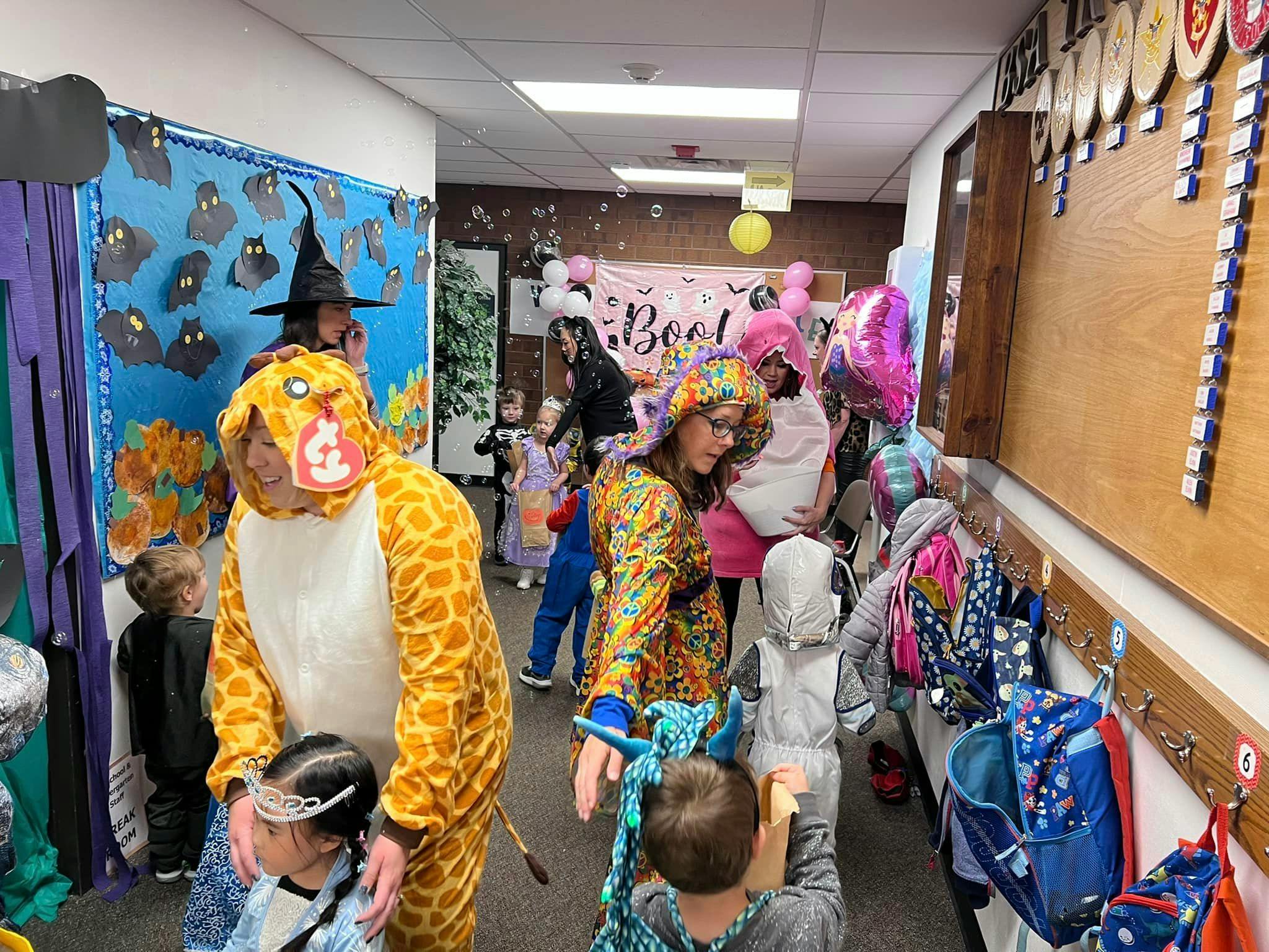 People and children in costumes in a hallway