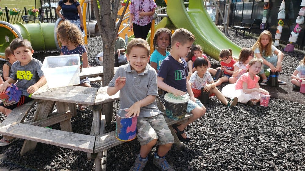 Children playing drums on a playground