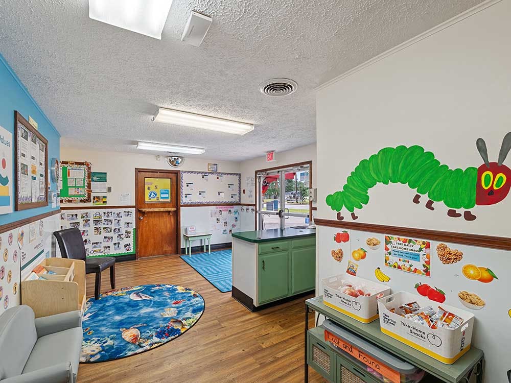 Classroom with The Very Hungry Caterpillar painted on the wall