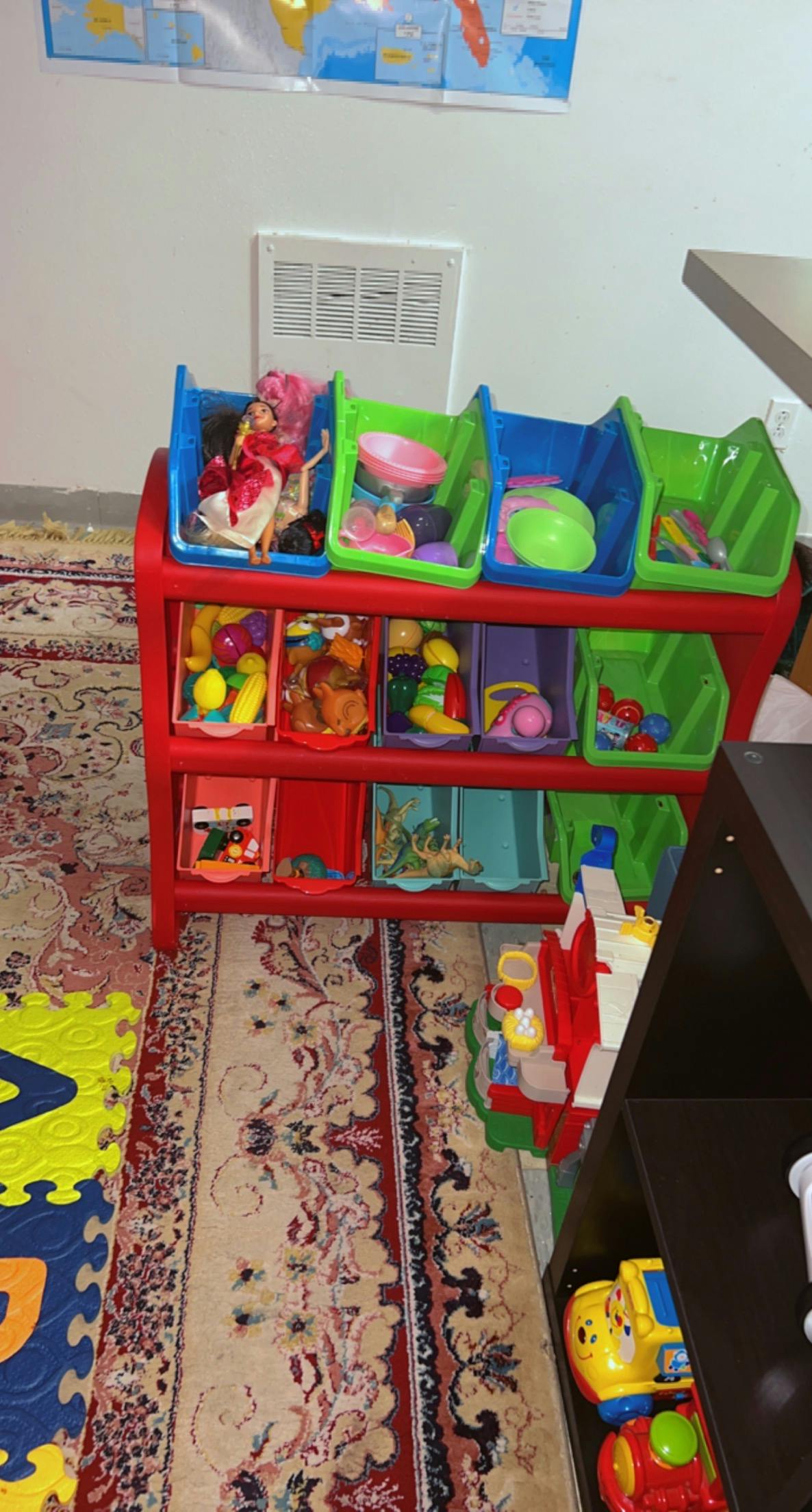 Red toy organizer with colorful bins filled with various toys