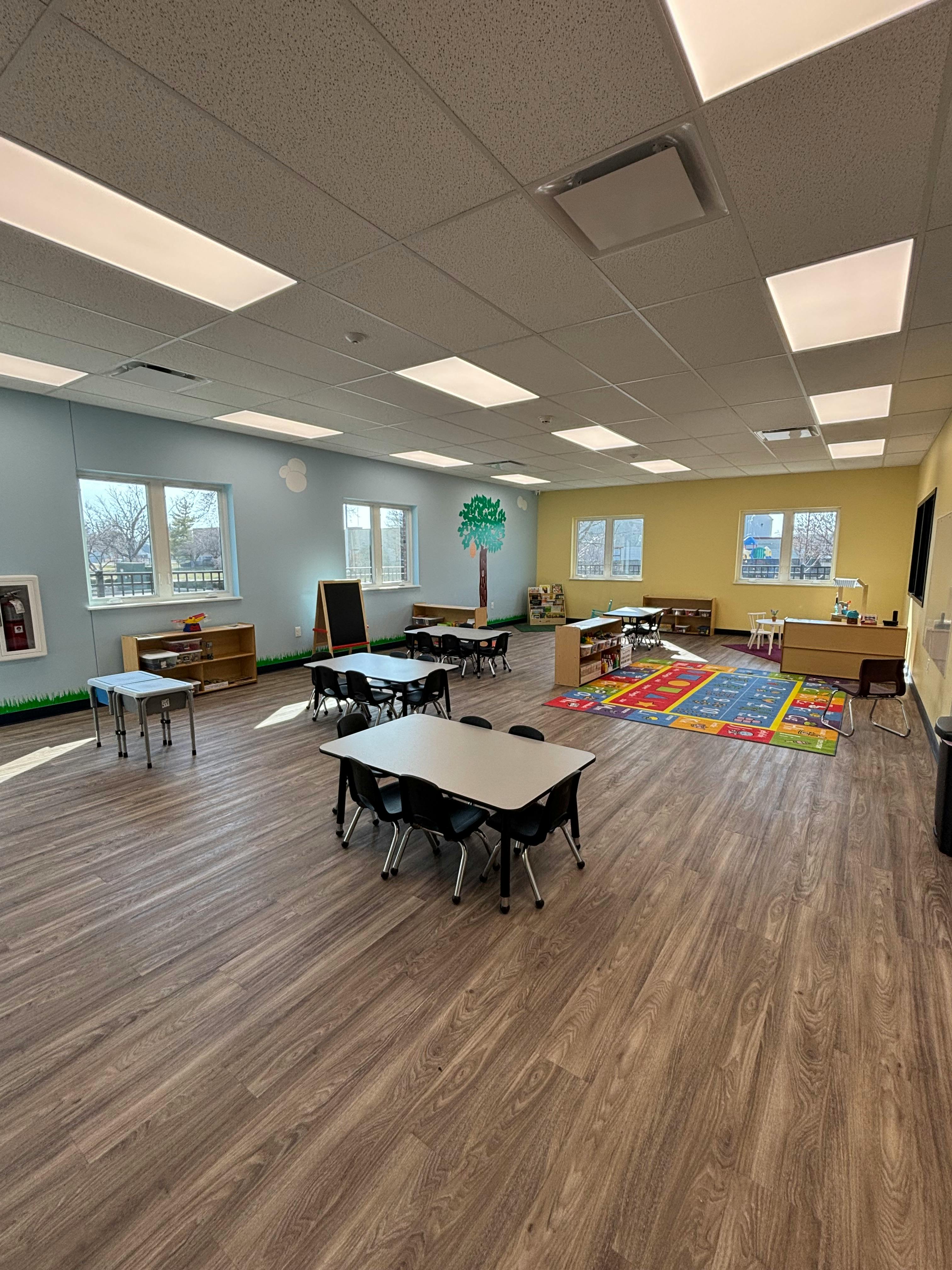 Empty classroom with small tables and chairs