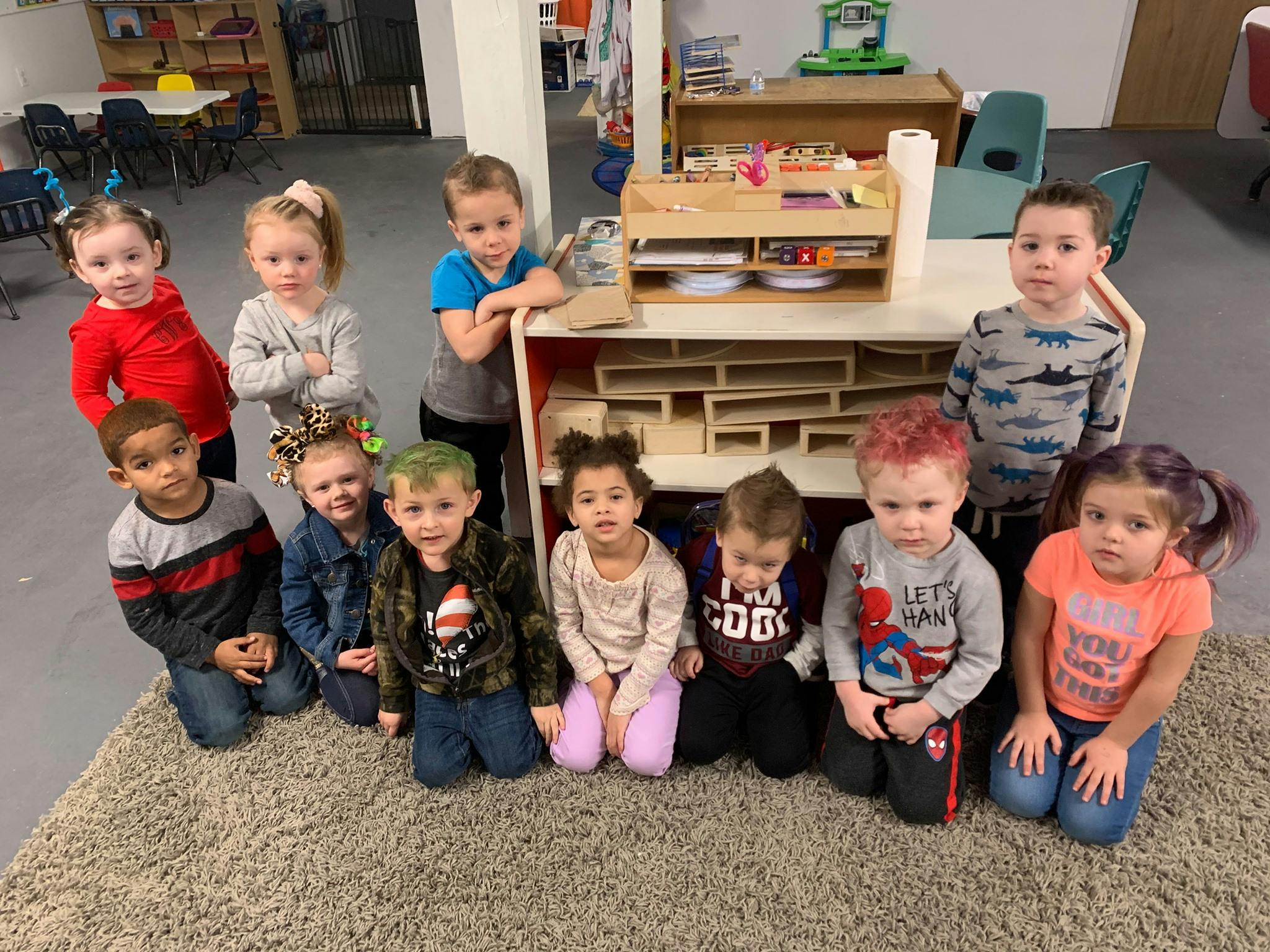 Group of children posing in a classroom