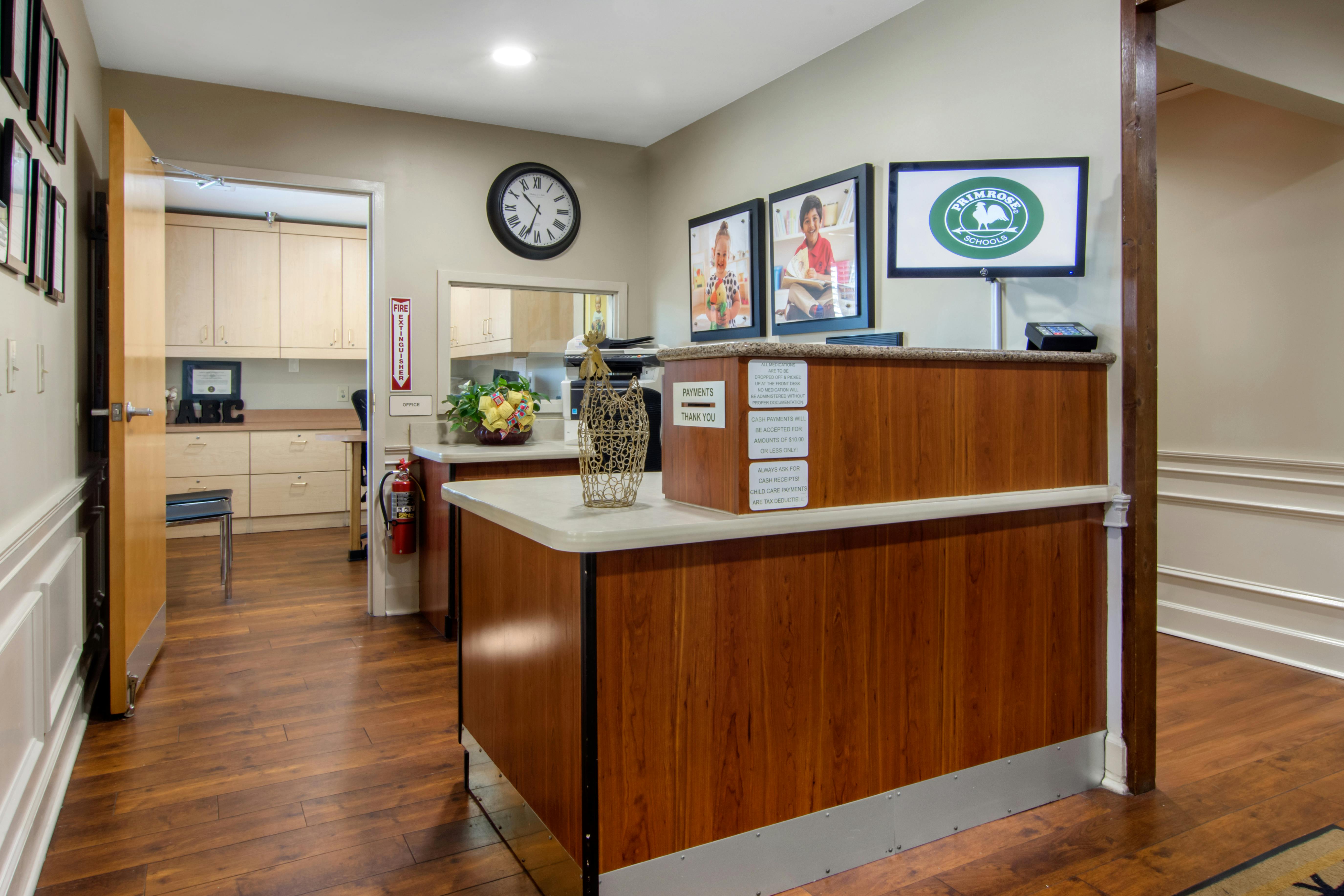 Reception desk with Primrose Schools logo on a monitor